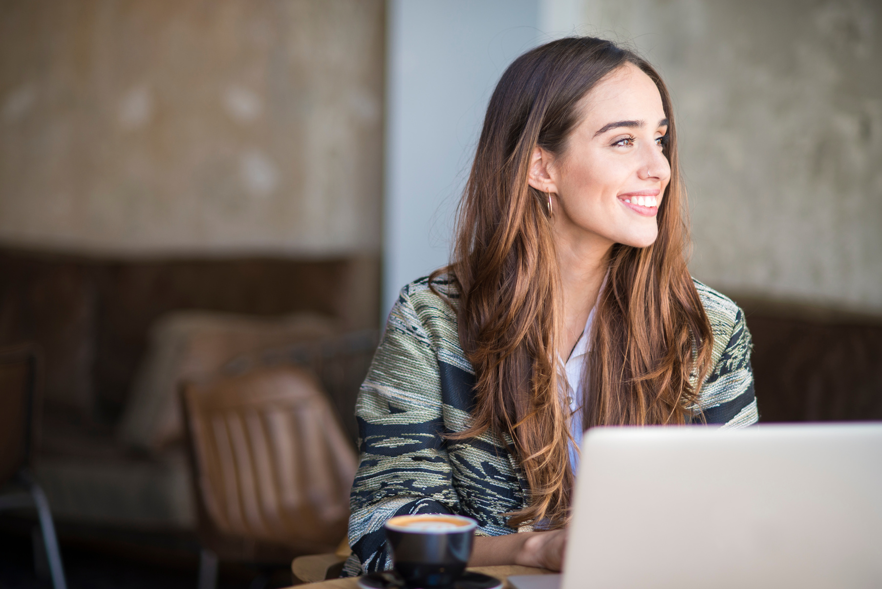 Smiling woman using computer.